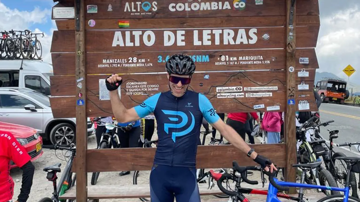 american cyclist celebrating at the top of the Alto de Letras in Colombia.